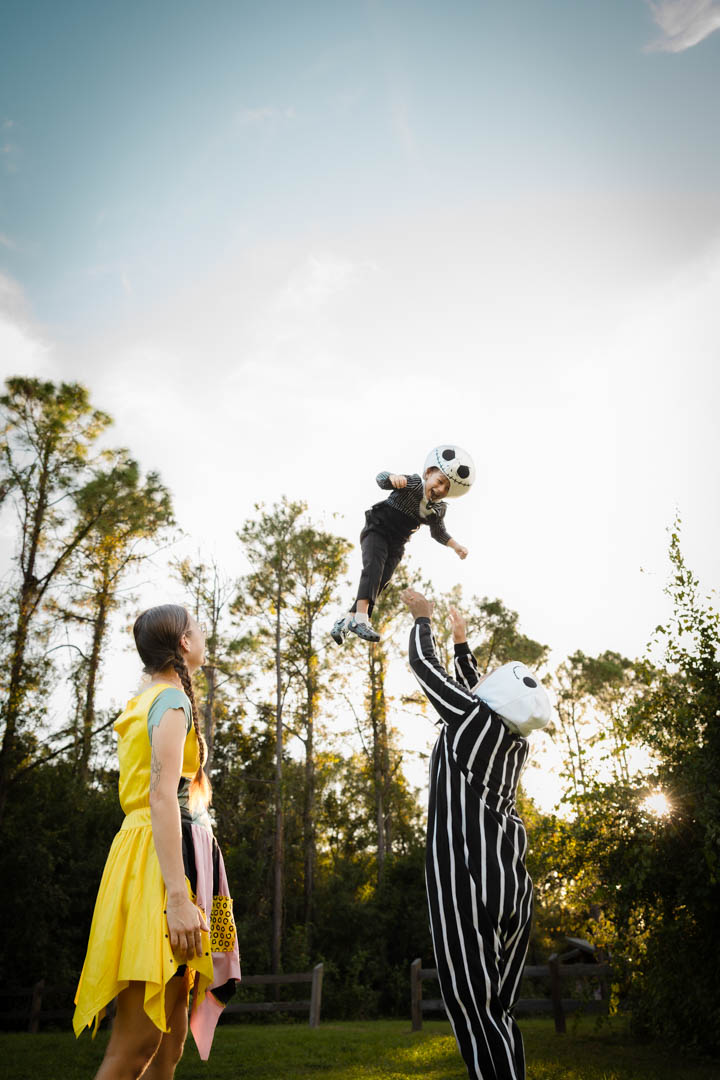 Parents tossing their son in the air, full joy