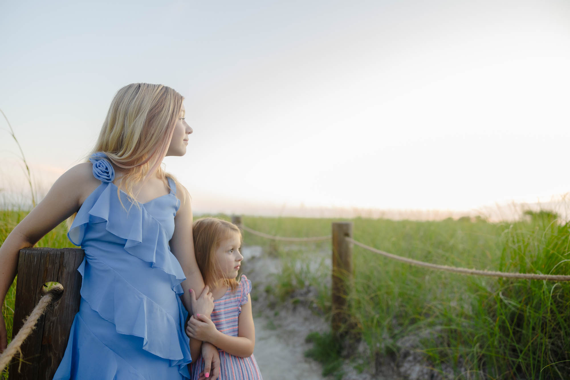 Kids looking toward the water, sunset glow
