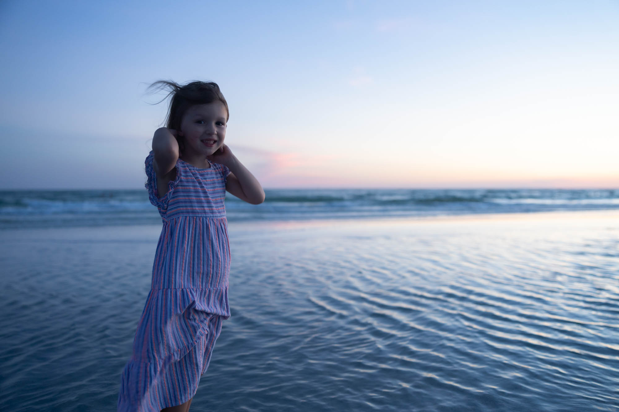 Family laughing together in soft Gulf light